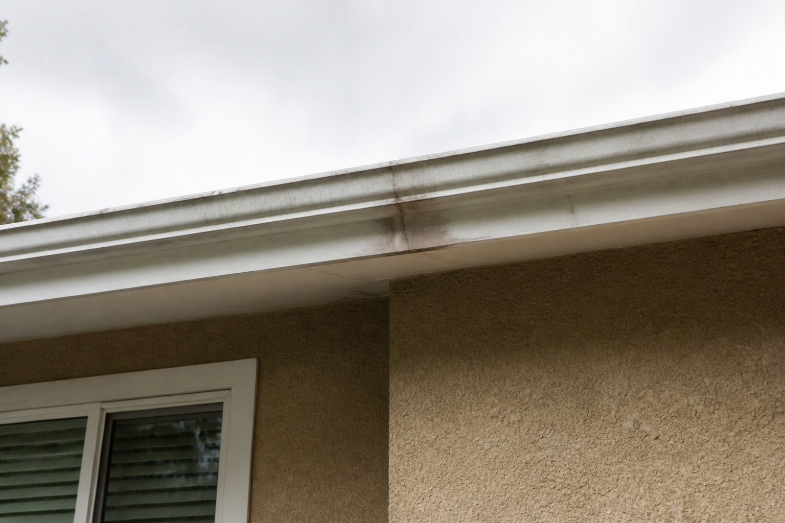 Eave, gutter, or secondary consequence detail before work on a roofing scenario typical of East Vancouver bungalows