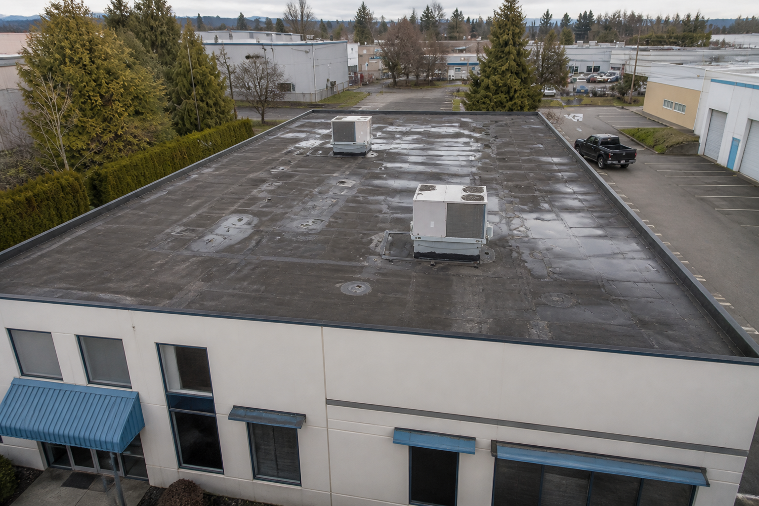 Eave, gutter, or secondary consequence detail before work on a roofing scenario typical of Richmond small commercial buildings